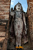 Thailand, Old Sukhothai - Wat Mahathat, 12-metre-tall statue of standing Buddha Phra Attharot enshrined in a roofless mandapa.  